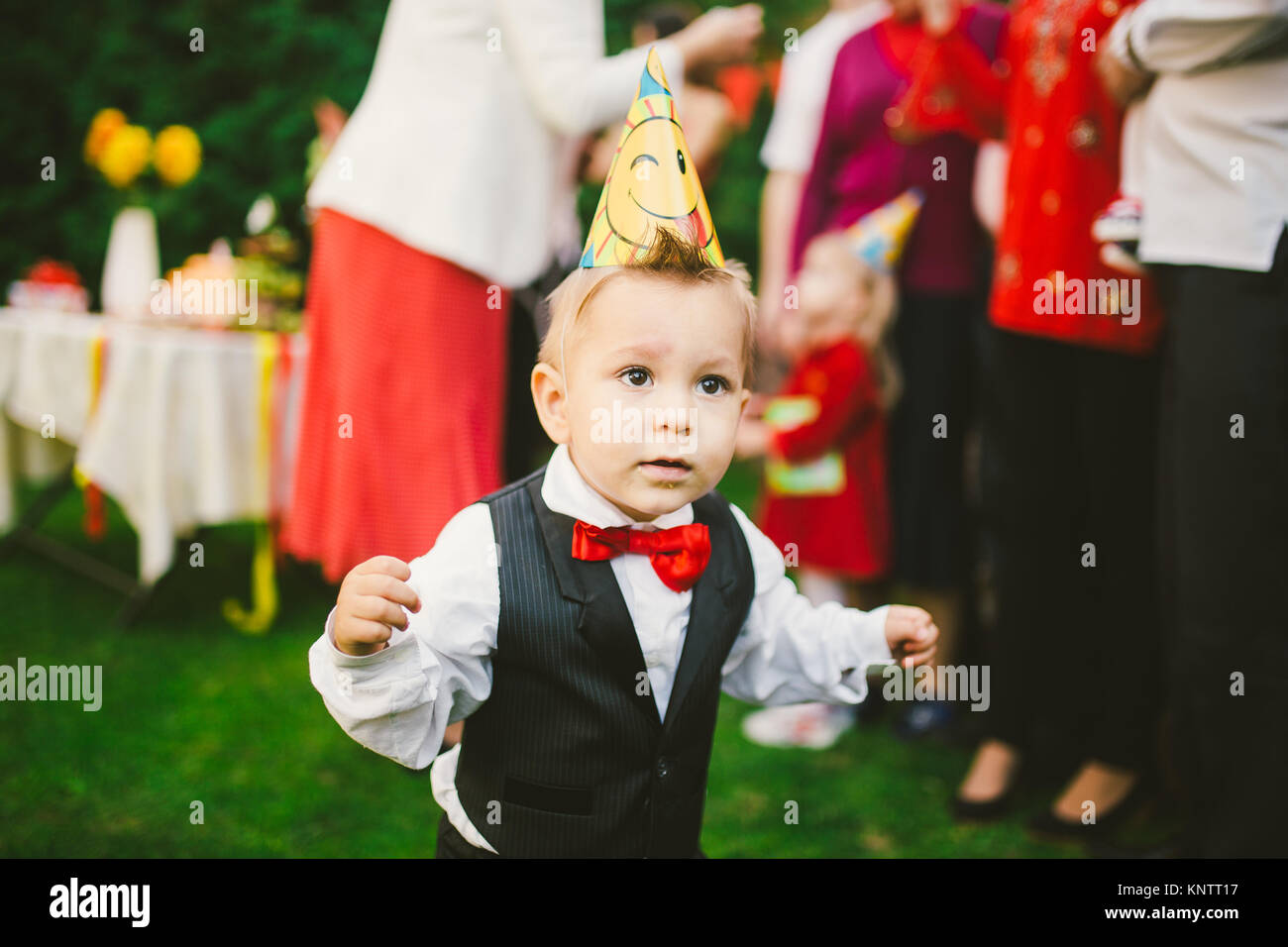 baby boy alone birthday in suit with with black vest, white shirt and