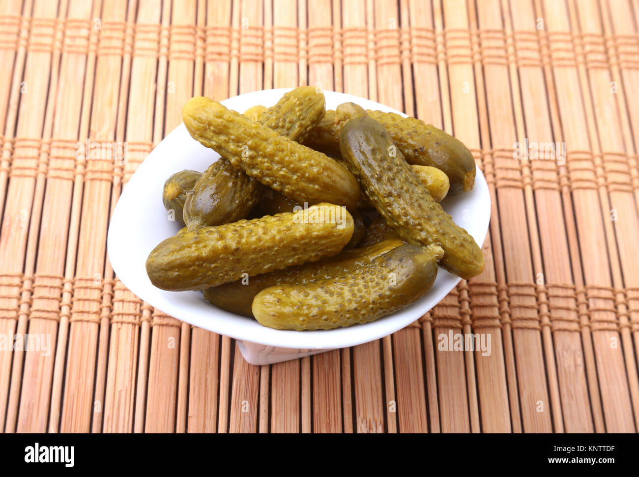Pickles. Bowl of pickled gherkins cucumber with copy space. Cornichons