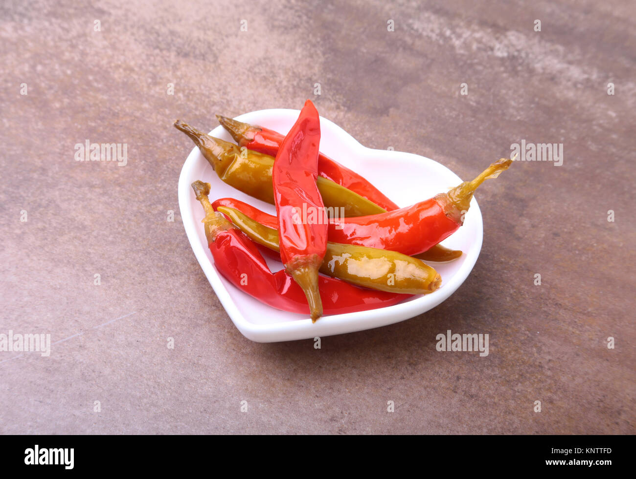 Bowl of pickled Red hot chili peppers on wooden background Stock Photo ...