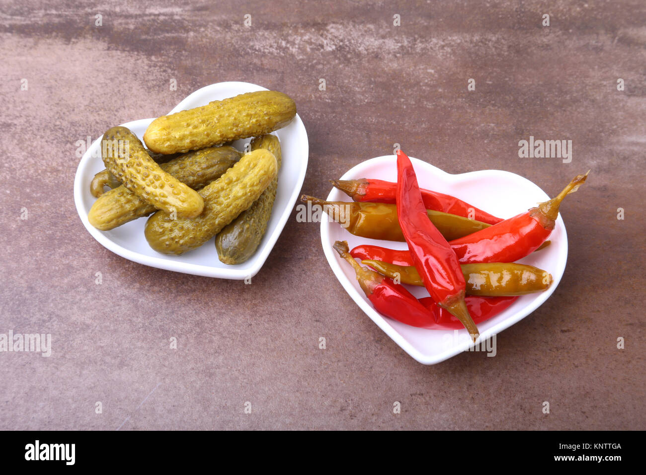 Bowl of pickled Red hot chili peppers on wooden background Stock Photo ...