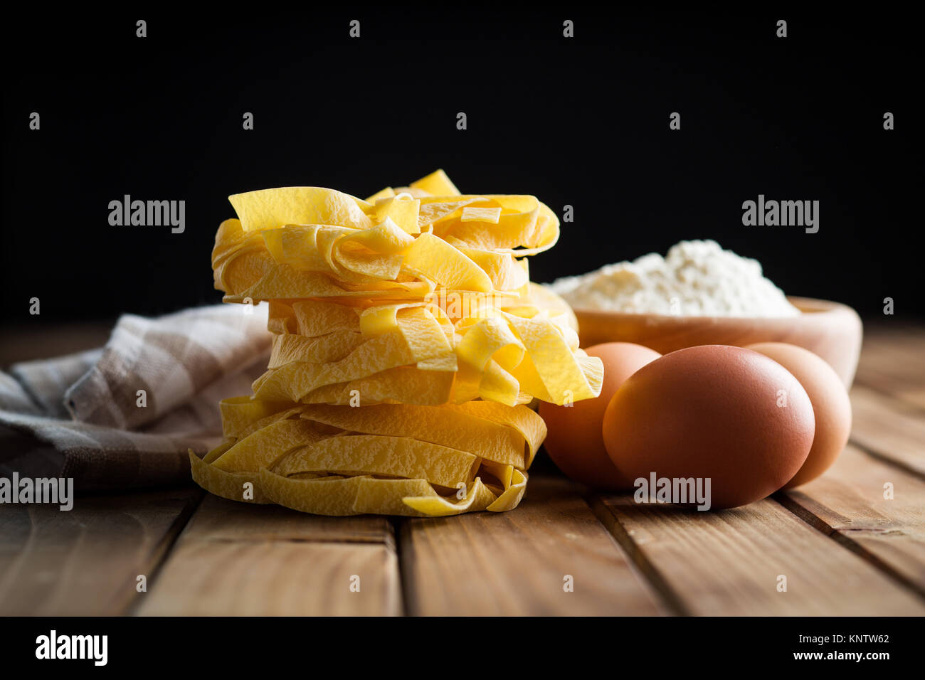 Raw tagliatelle pasta, flour and eggs Stock Photo Alamy
