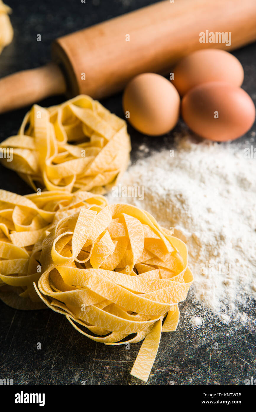 Raw tagliatelle pasta, flour and eggs Stock Photo Alamy