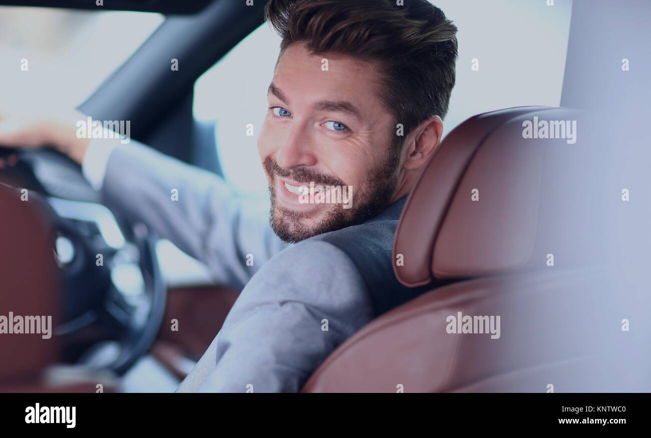 Portrait of an handsome smiling business man driving his car Stock ...