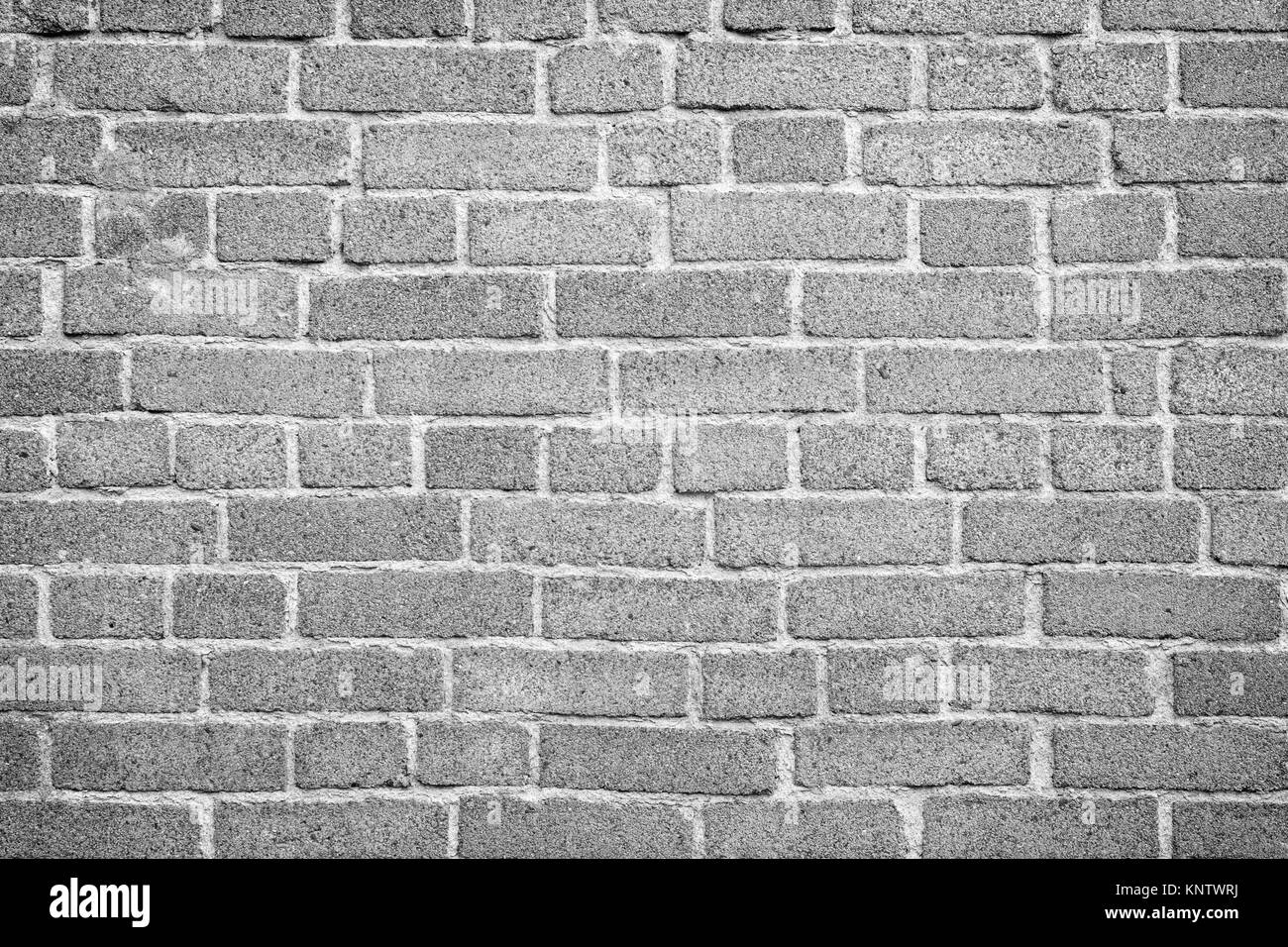 Brick wall texture background in black and white with vignetting. Stock Photo
