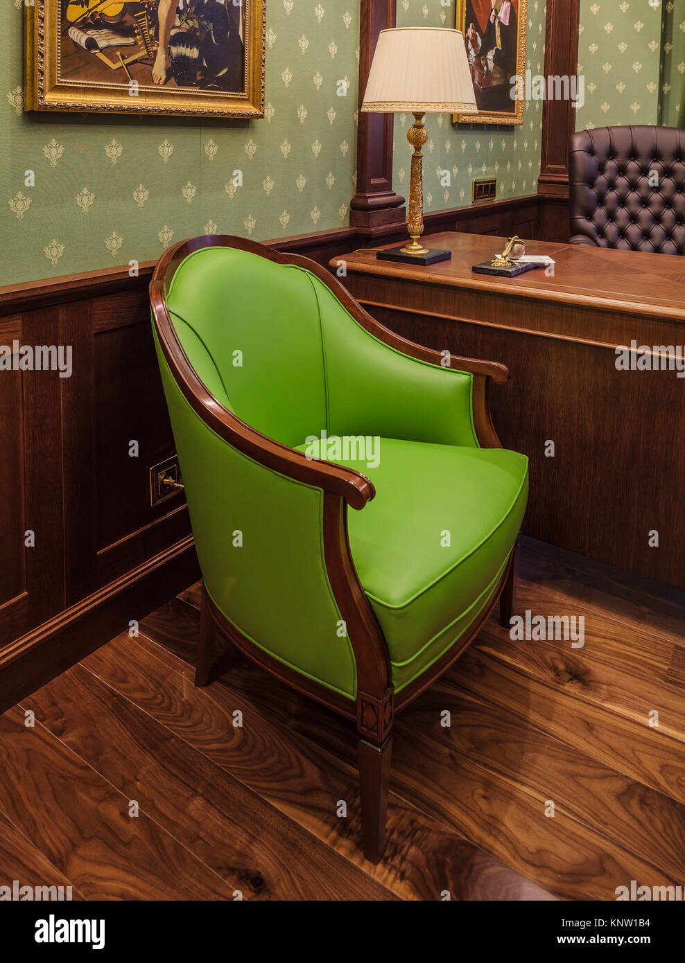 Green armchair in classic interior of cabinet Stock Photo