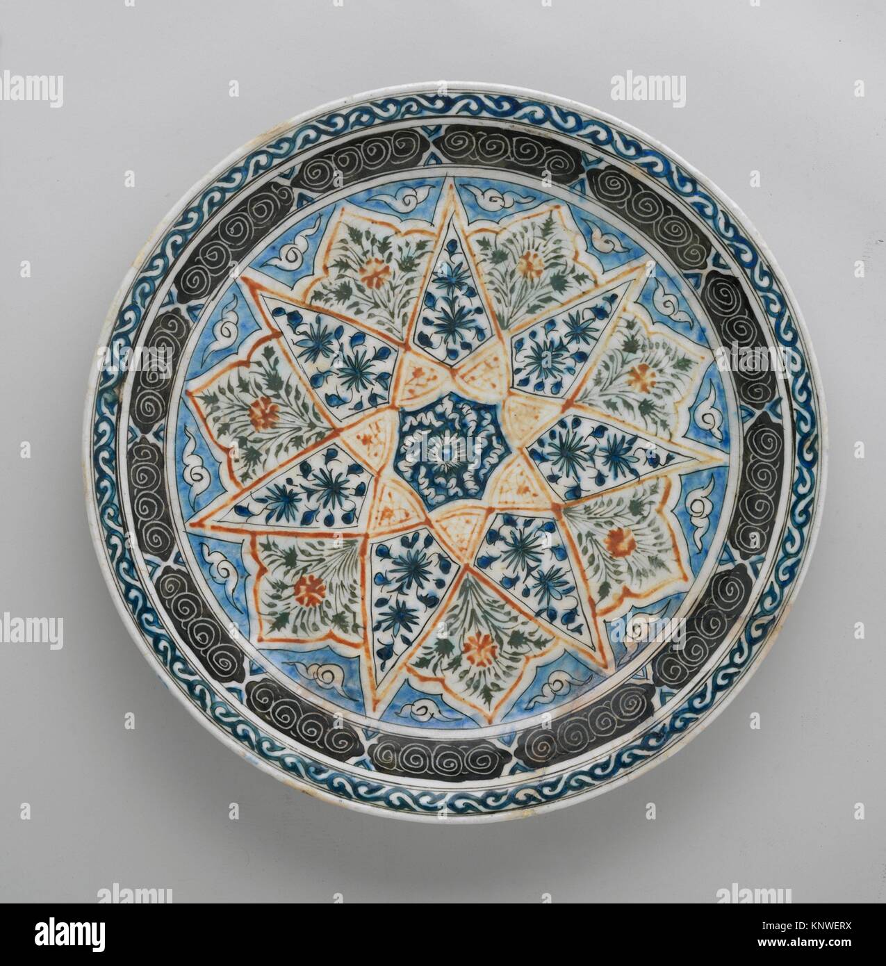 Plate with Vegetal Decoration in a Seven-pointed Star. Object Name: Plate; Date: 17th century; Geography: Attributed to Kirman. Made in Iran; Medium: Stock Photo