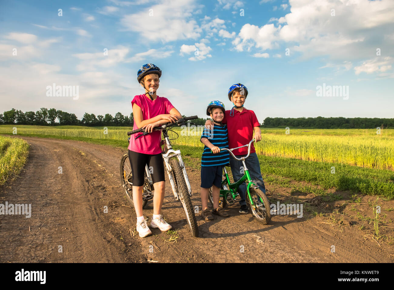 Sporty children in helmets with bikes Stock Photo