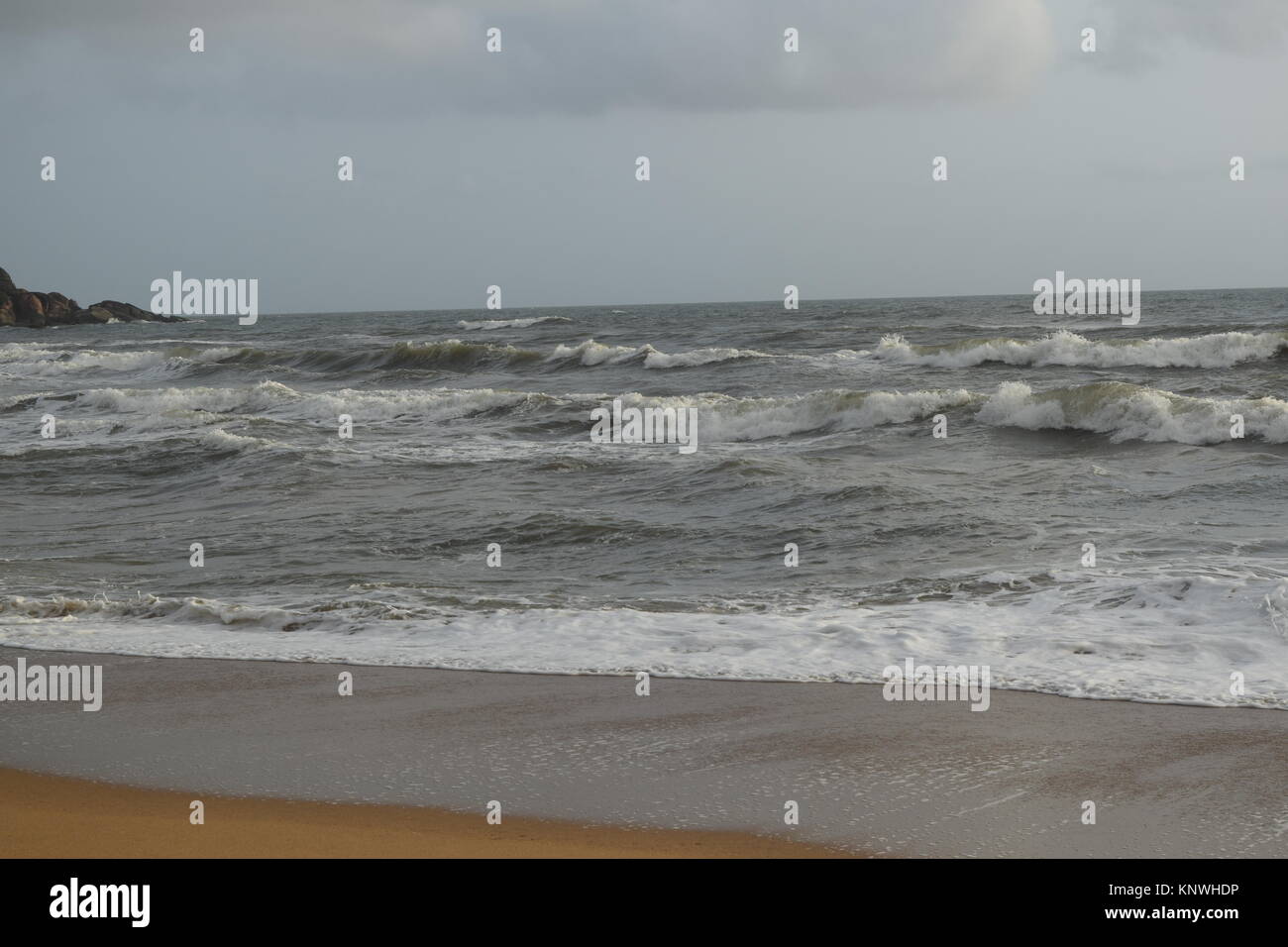 Sandy beach images on a cloudy day. Cool beach with no people. Beautiful beach background for website or desktop. Seashore / ocean / beach view. Stock Photo
