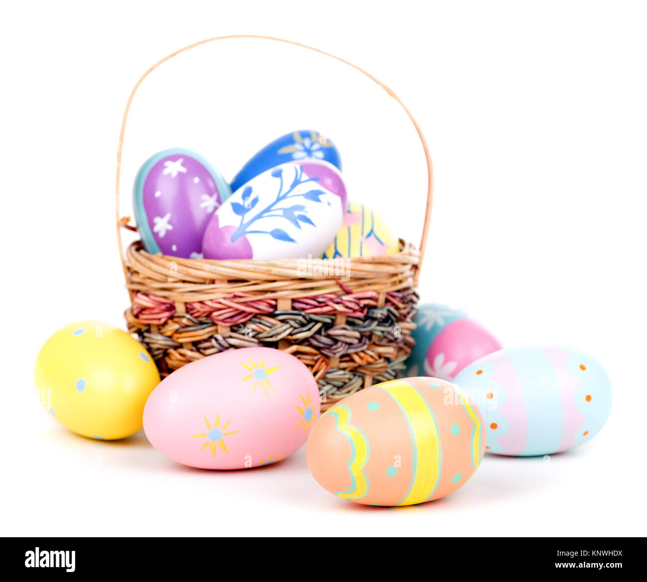 Decorated Easter eggs and basket on a white background Stock Photo