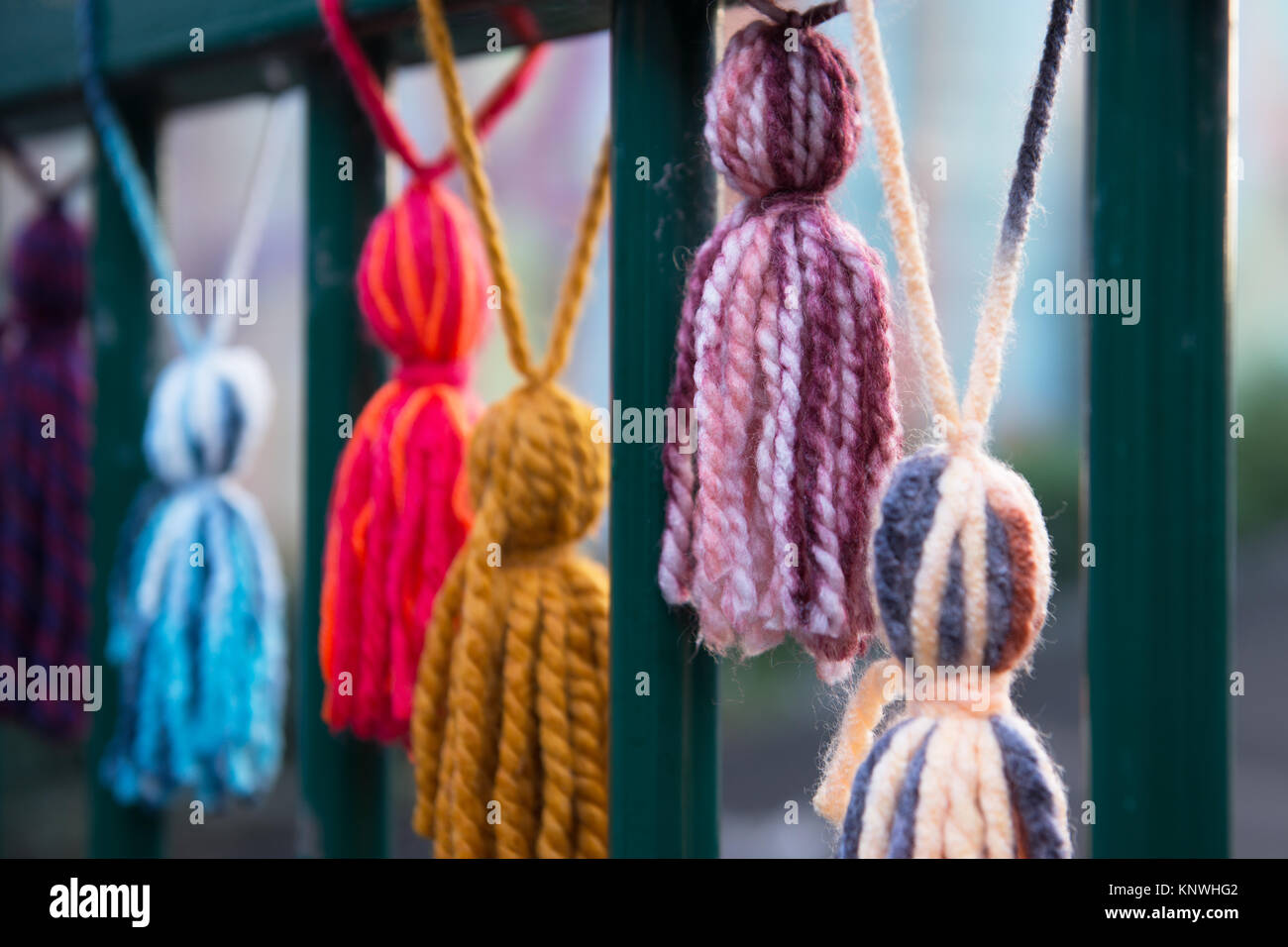 Wool brushes attached to fences on the street in frame of Urban Knitting action amateurs decorate center of Mons, Belgium, on October 18, 2017 Stock Photo