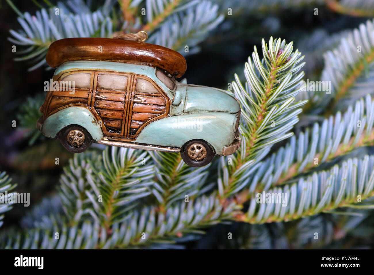 Retro car with canoe on top Christmas Ornament on a silver Christmas tree Stock Photo