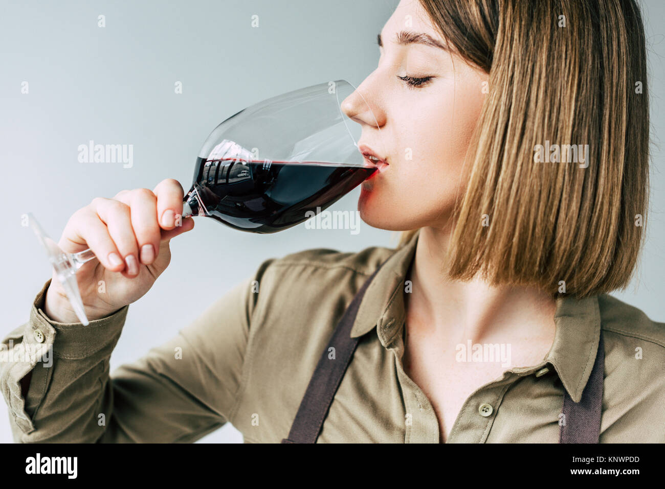 Female sommelier tasting red wine  Stock Photo