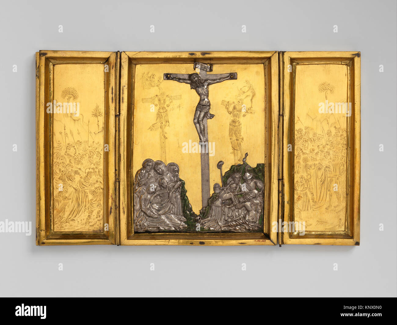 Triptych with the Way to Calvary, the Crucifixion, and the Disrobing of Jesus. Date: ca. 1400-1420; Culture: Netherlandish or French; Medium: Gilded Stock Photo