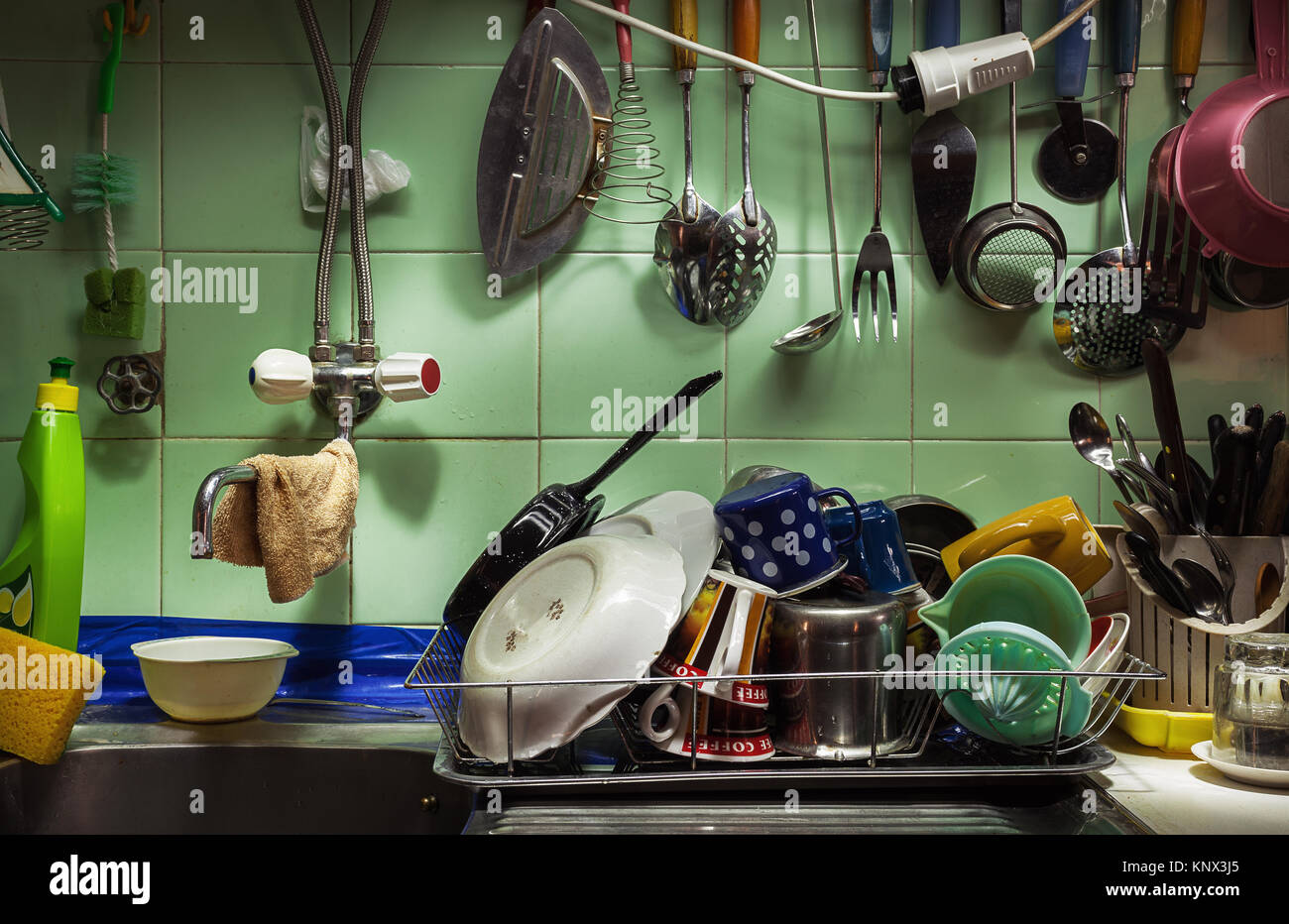Details of an old kitchen, various washed dishes, cutlery, crockery and