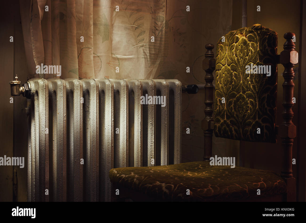 Scene from ordinary life, old retro chair and radiator Stock Photo - Alamy
