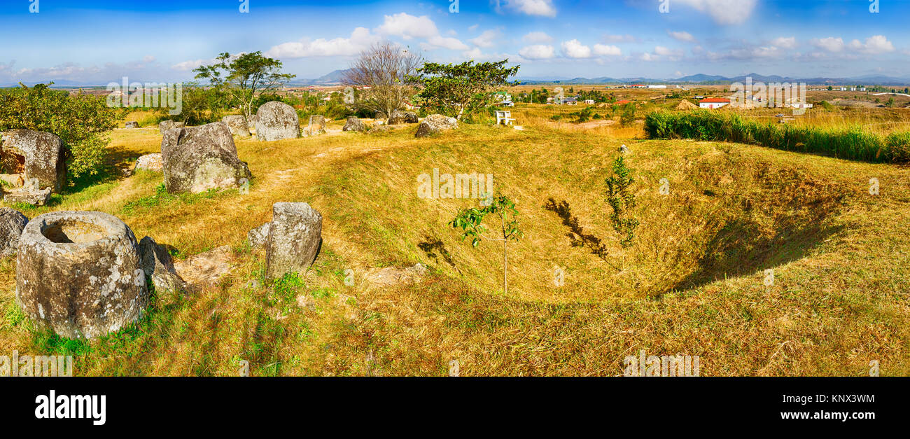 Archaeological landscape The Plain of jars. Bomb crater and jars. Laos. Panorama Stock Photo