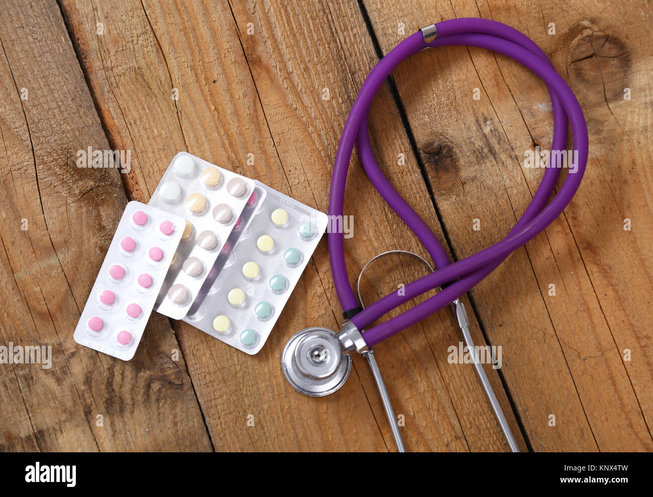 Medical stethoscope and tablets isolated on wooden background Stock ...