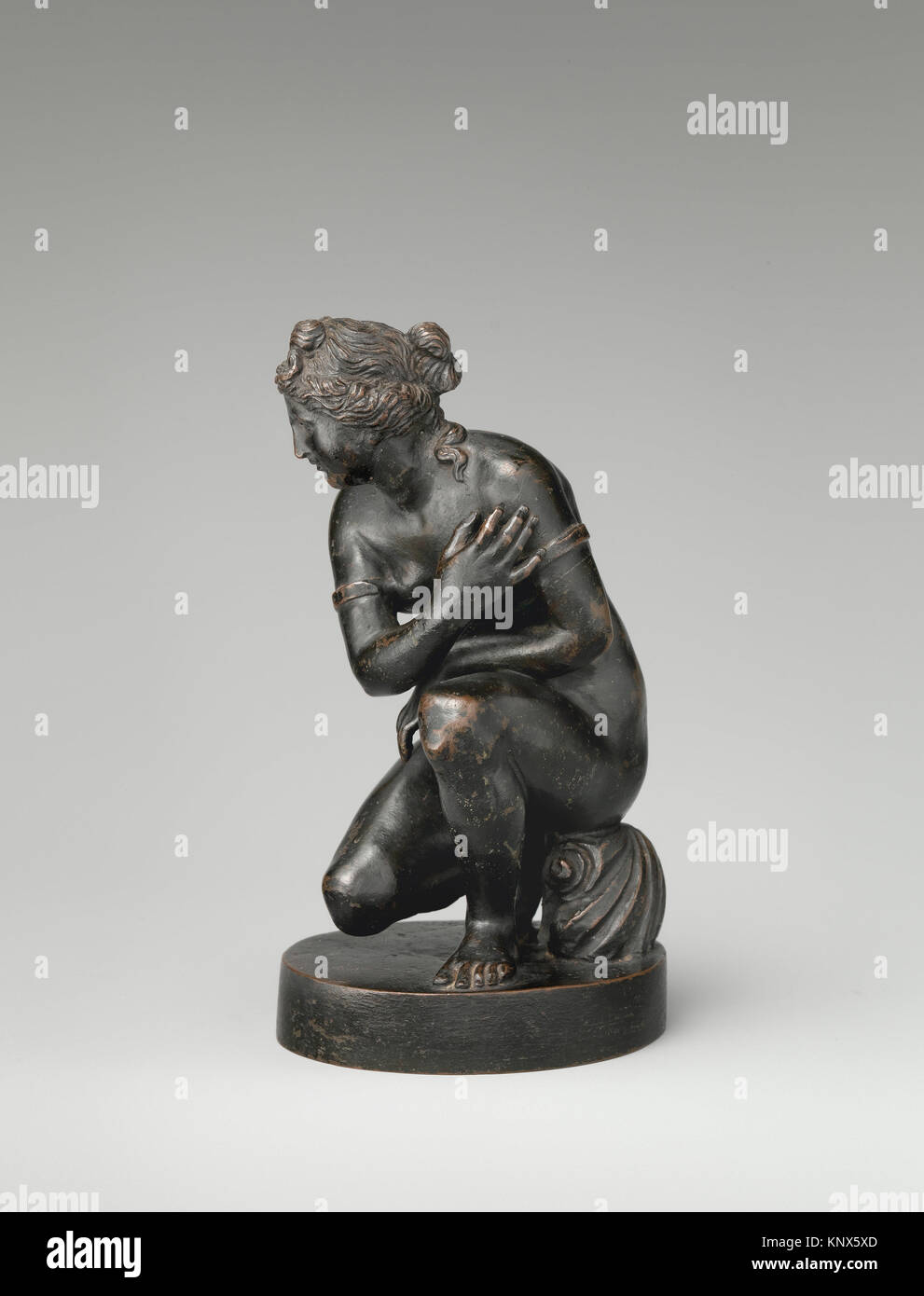 The Crouching Aphrodite of Doedalsas. Date: 17th-18th century; Culture: Italian; Medium: Bronze, black lacquer patina; Dimensions: Height: 5 3/4 in. Stock Photo