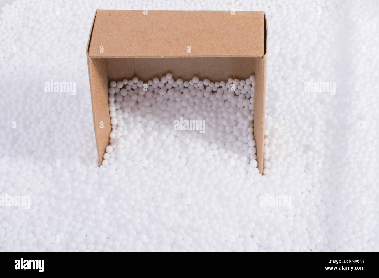 Box on little white polystyrene foam balls Stock Photo - Alamy