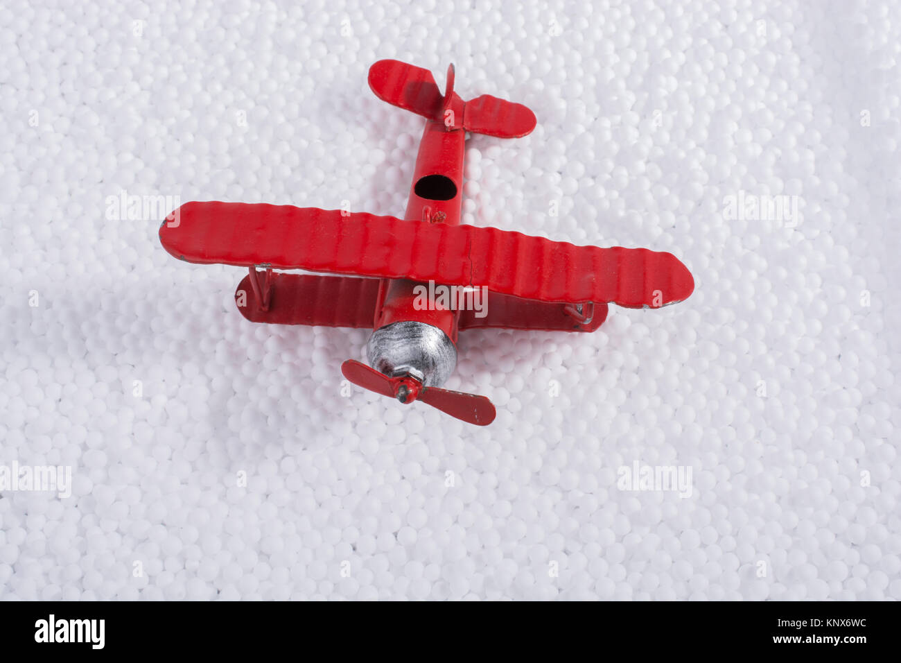 Toy airplane on little white polystyrene foam balls Stock Photo - Alamy