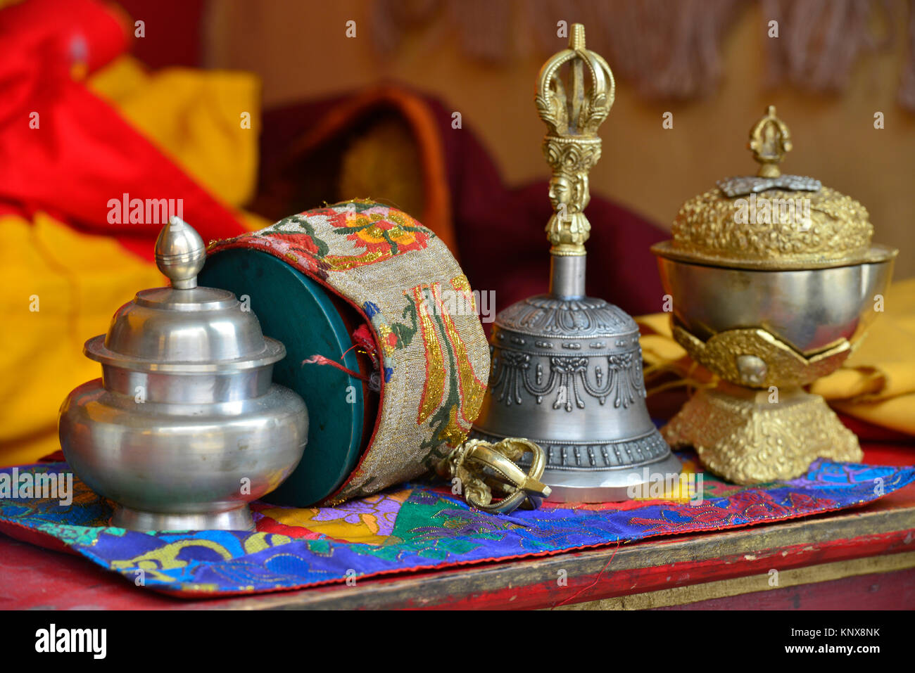 Prayer table of a Buddhist monk a ritual bell, a drum, a bowl are ready for a puja in a