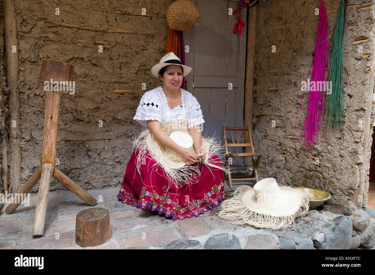 Panama Hats - Cuenca Ecuador - an ecuadorian woman demonstrating the traditional weaving of a Panama Hat, Homero Ortega Hats, Cuenca, Ecuador Stock Photo