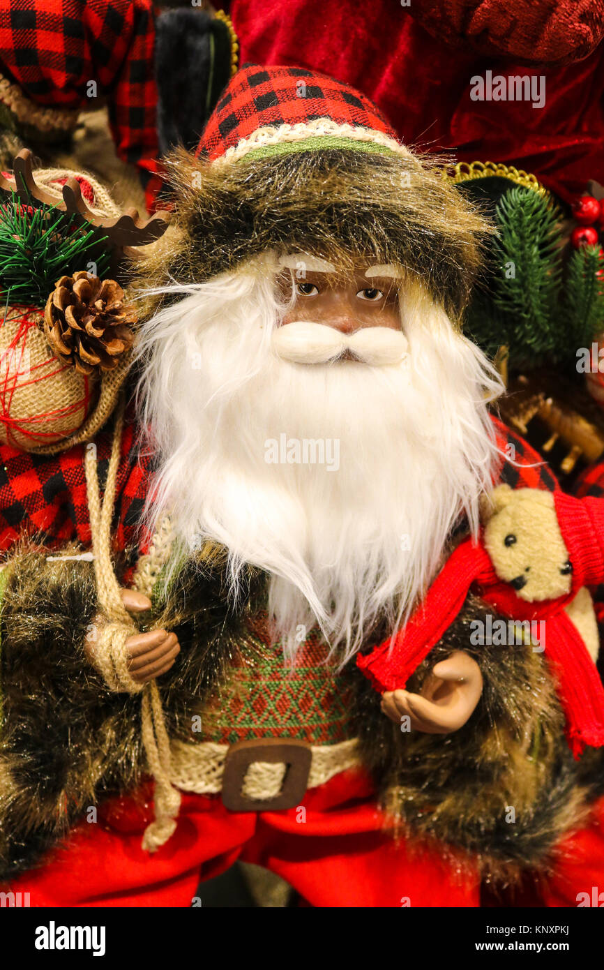 Woodland santa with knit vest plaid hat and a teddy bear with foliage and pinecones Stock Photo