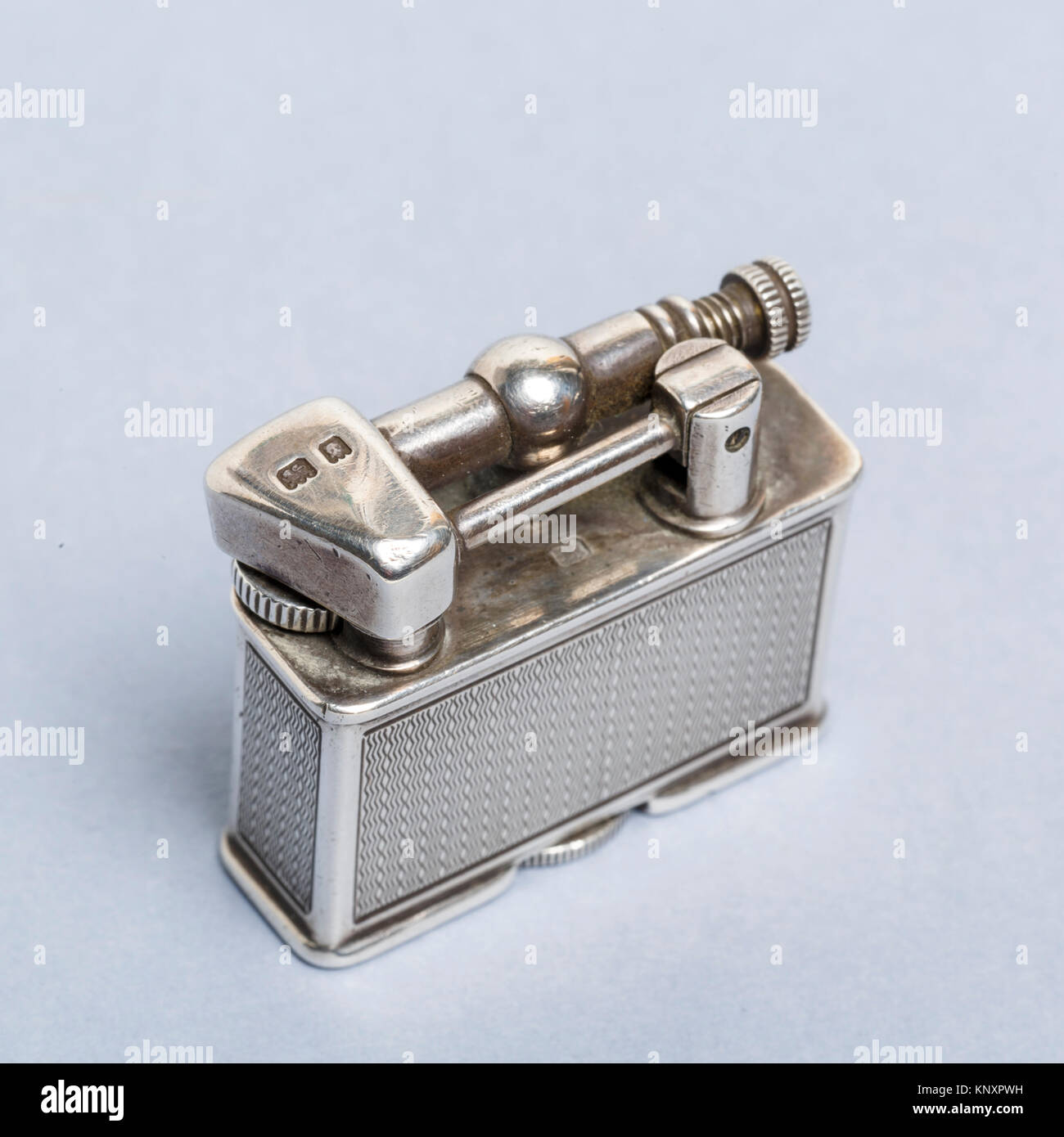 Small cigarette lighter in hallmarked silver made by Parker Beacon, a subsidiary of Dunhill.  Hallmarked P.P.Co. for Parker Pipe Company. Stock Photo