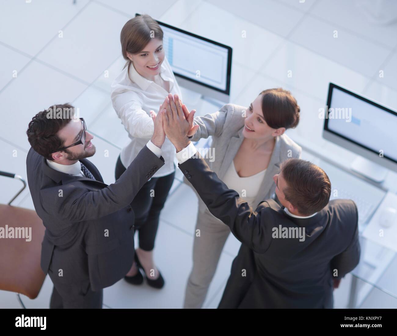 successful business team giving each other a high-five, standing in the ...