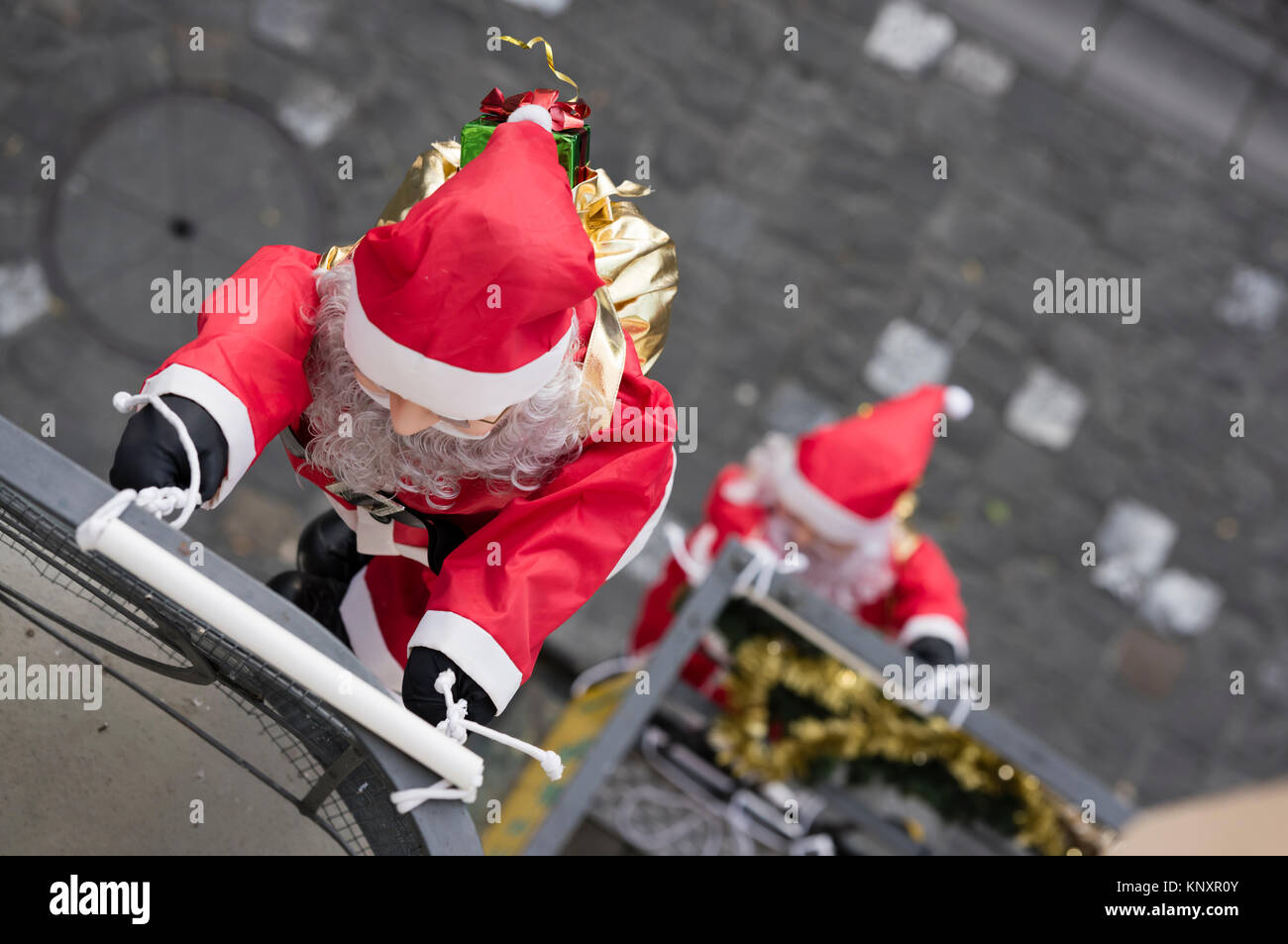 Lucerne, Switzerland - 3 Dec 2017: As Christmas decorations, a rope team of Santa Claus puppets is climbing up the facade of a house at Lucerne, Switz Stock Photo