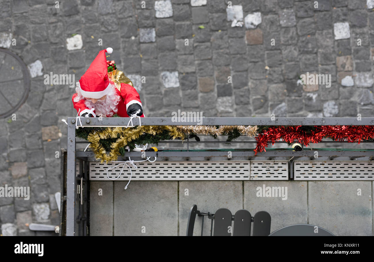 Lucerne, Switzerland - 3 Dec 2017: As Christmas decorations, a Santa Claus puppet with Christmas presents is climbing up the facade of a house at Luce Stock Photo
