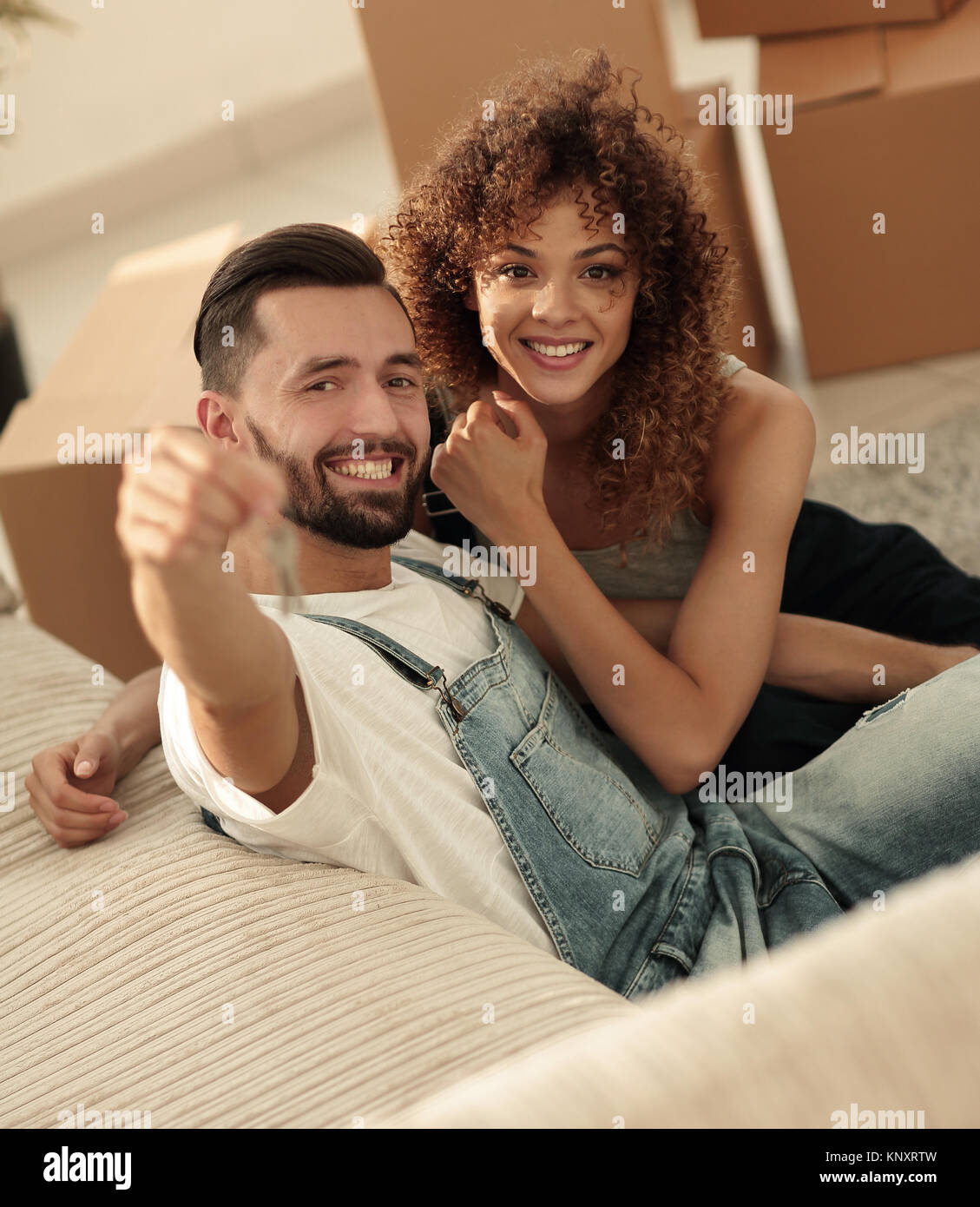 young couple holding the key to a new apartment Stock Photo - Alamy
