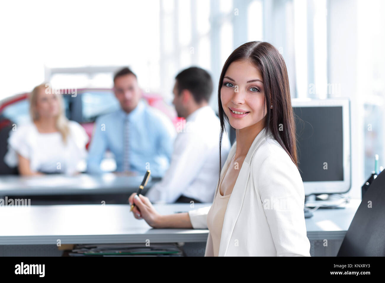 portrait of young business woman sitting at the Desk Stock Photo - Alamy