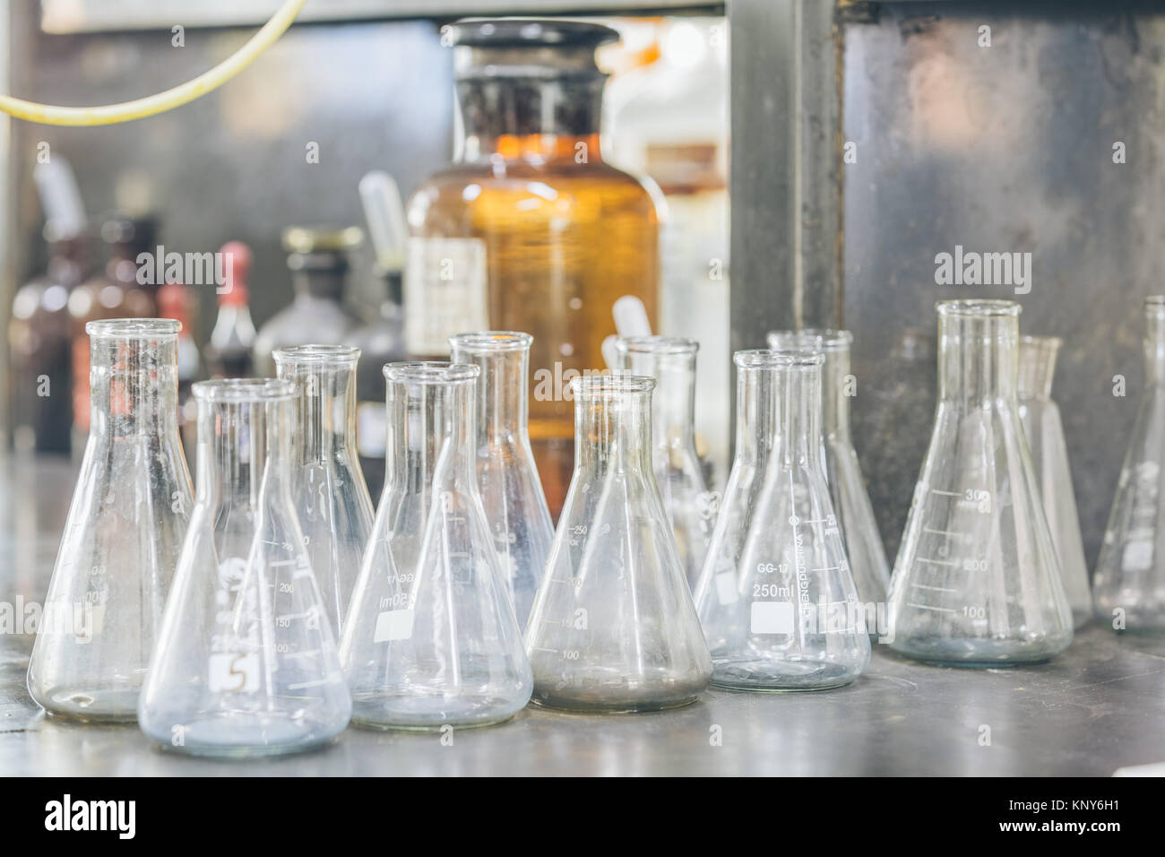 detail shot of beakers and equipment on table in factory laboratory ...