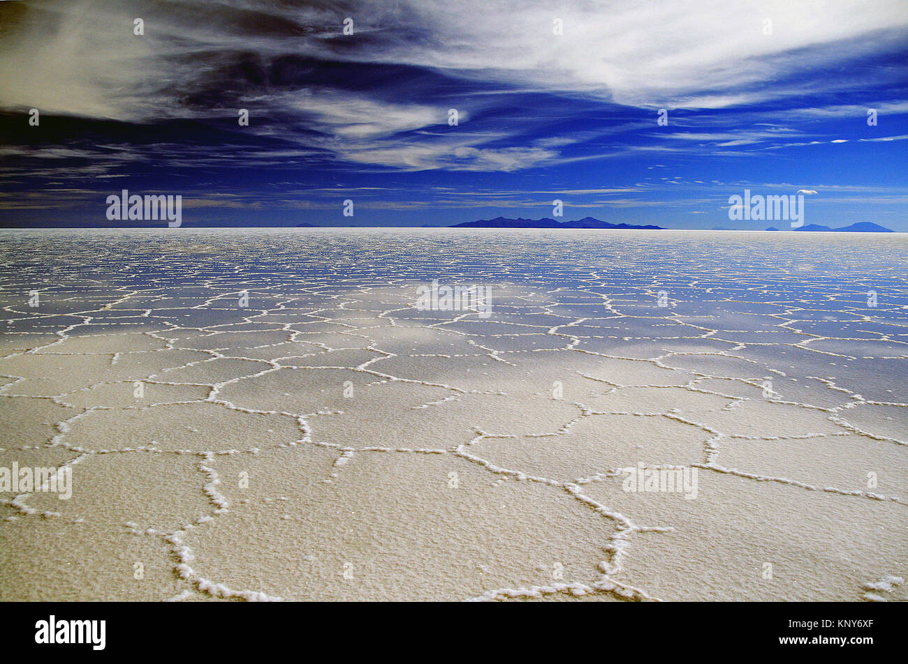 Salt flats of Uyuni in Bolivia with reflection of sky off shallow water on the ground Stock Photo
