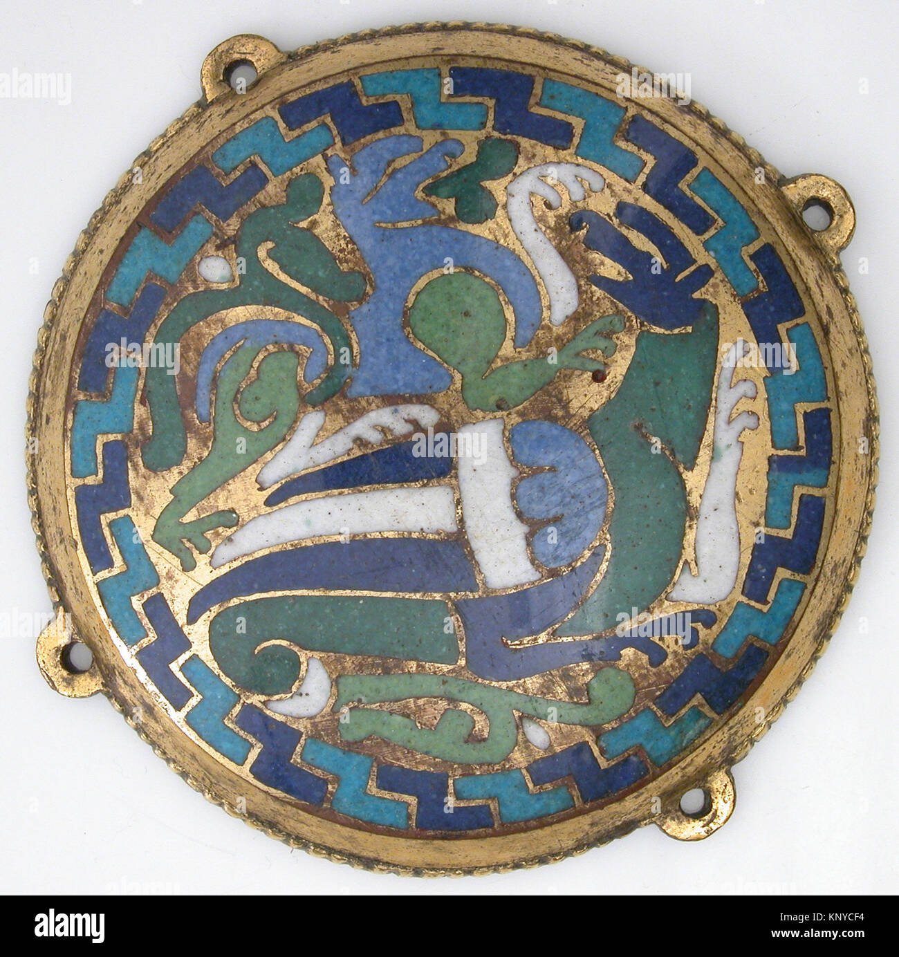 Combat Between Dragon and Dog (one of five medallions from a coffret) MET sf17-190-691s1 464564 French, Combat Between Dragon and Dog (one of five medallions from a coffret), ca. 1110?30, Copper-gilt, champlev? enamel, Overall: 3 9/16 x 1/2 in. (9 x 1.3 cm) Overall (with nail tangs): 3 7/8 x 1/2 in. (9.8 x 1.3 cm). The Metropolitan Museum of Art, New York. Gift of J. Pierpont Morgan, 1917 (17.190.691) Stock Photo