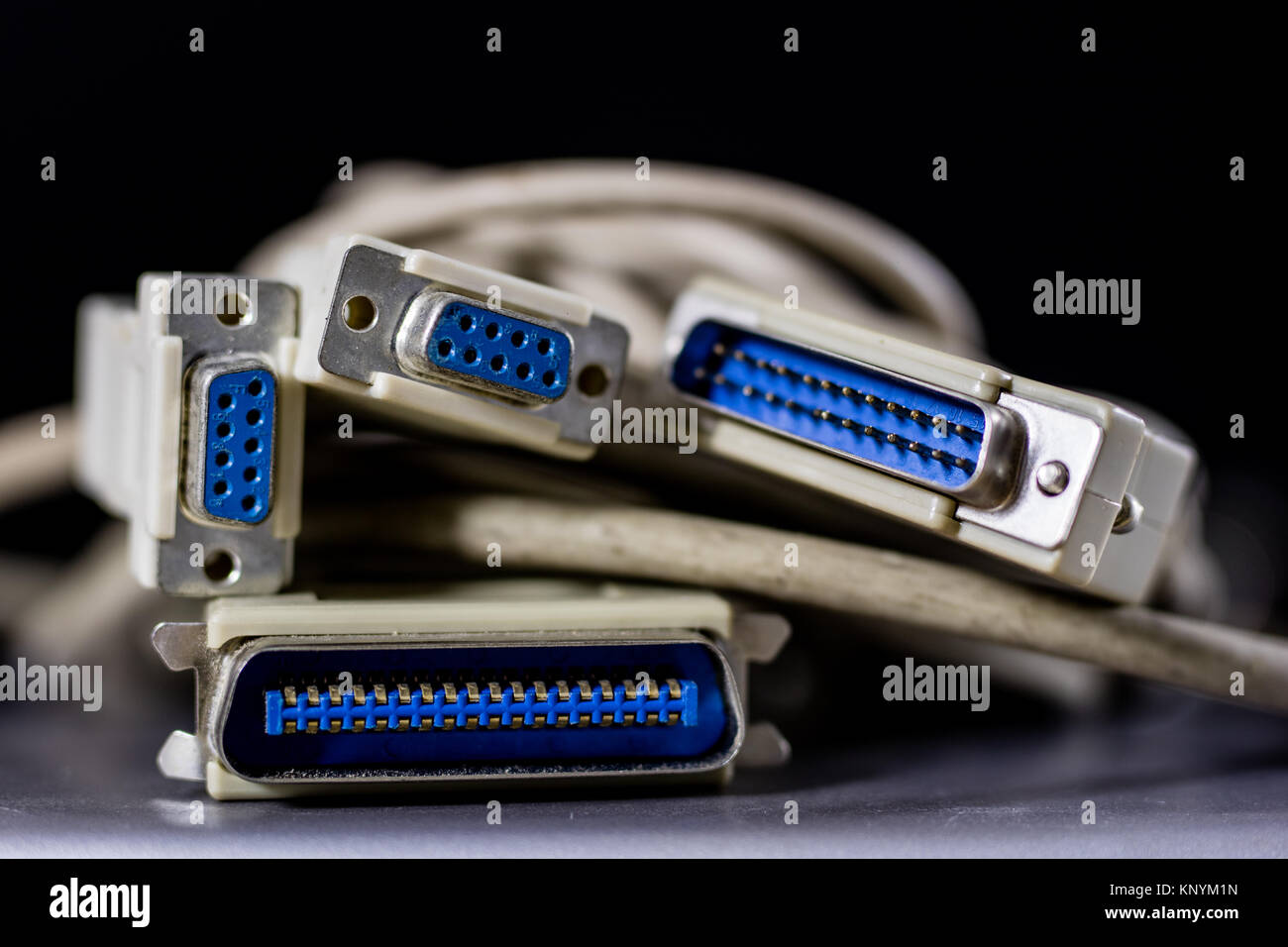 old computer wires. Cables lpt, com1 and com2 for desktop and laptop computers. Wooden table