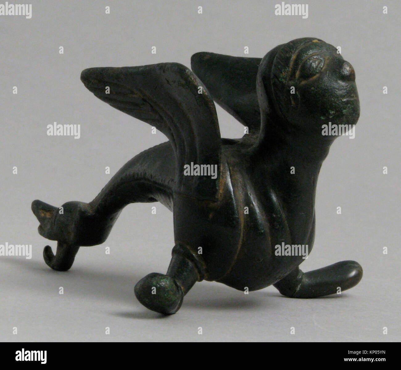 Fabulous Winged Creature with Human Face, probably from the foot of a candlestick. Date: 12th century; Geography: Made in Meuse valley, Netherlands; Stock Photo