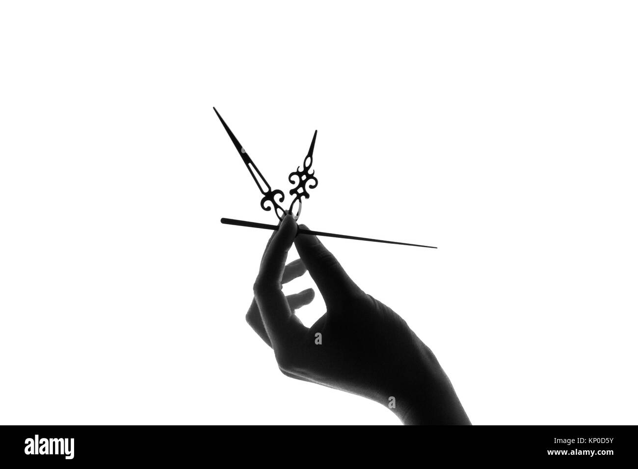 silhouette of a clock in a young female hand on white background. Time