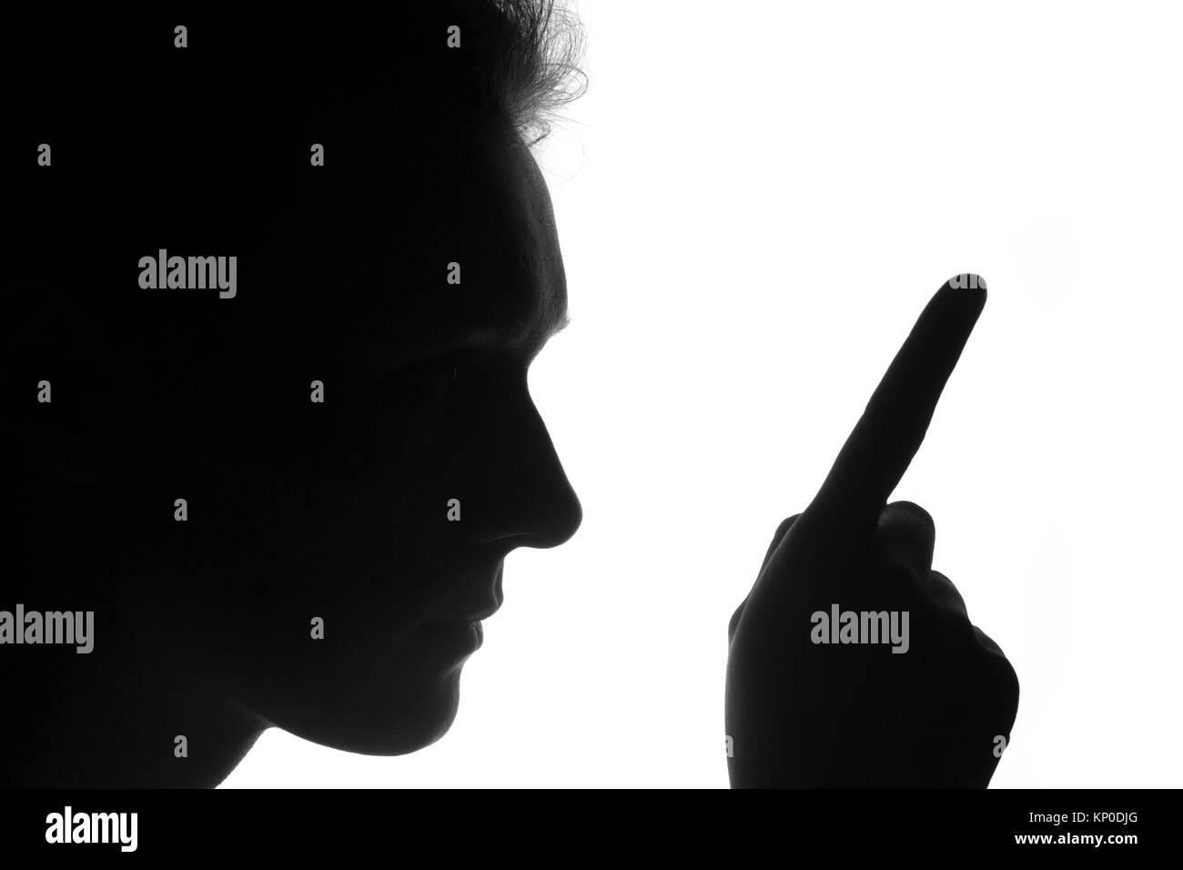 silhouette of a hand person in profile with a finger pointing up on a white background. Think concept or pointing do or idea or forward concepts Stock Photo