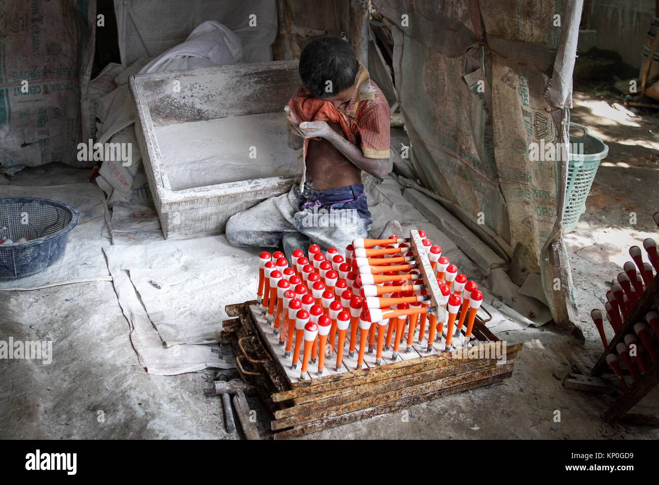 Bangladeshi child labor working in a balloon factory in Dhaka. Child labor is very common in almost every industry of Bangladesh such as Aluminum Stock Photo