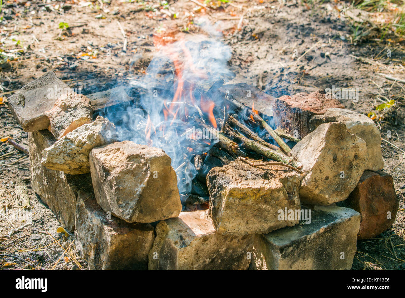 On a hot summer day, burn a fire in the forest. Many firewood Stock Photo