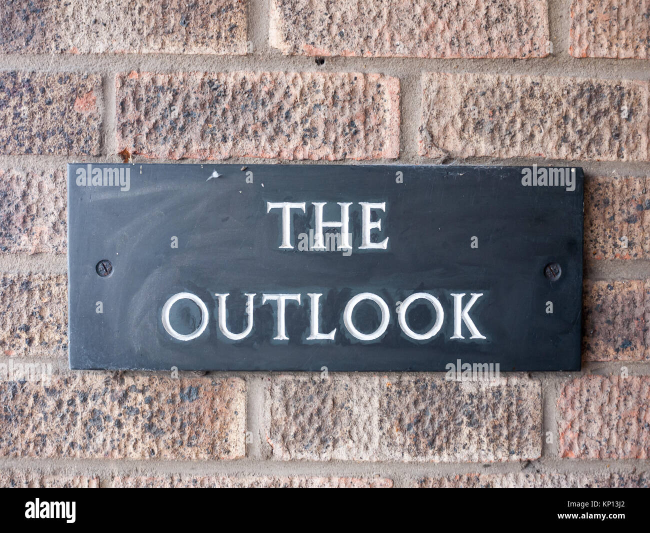 close up of black house sign the outlook on brick wall; essex; england