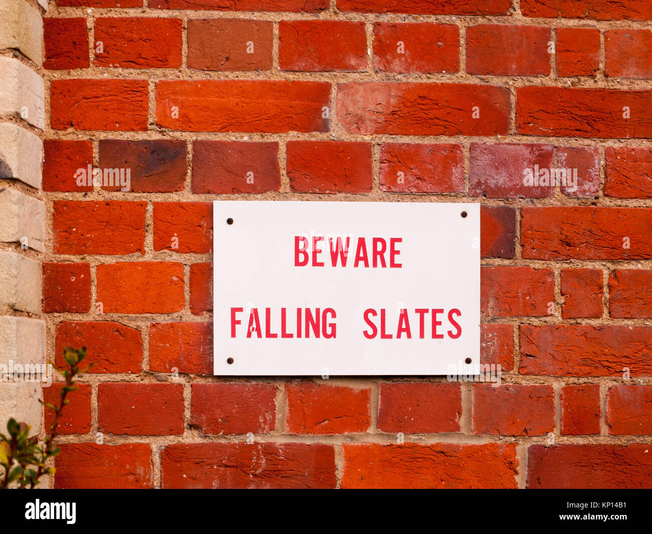 information sign on red brick wall beware falling slates; essex ...
