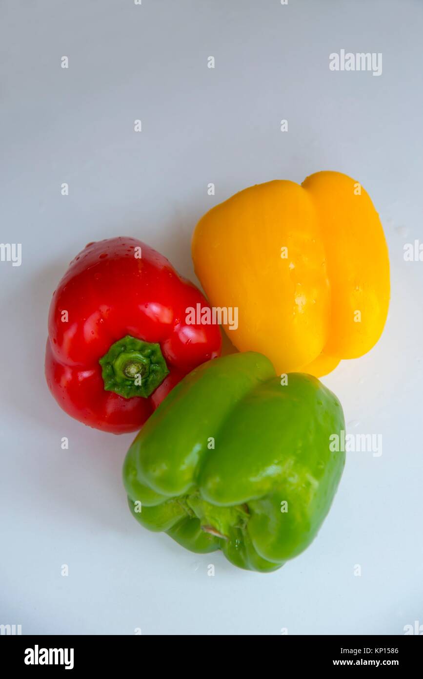 Three assorted peppers: red, yellow and green. Still life. Stock Photo