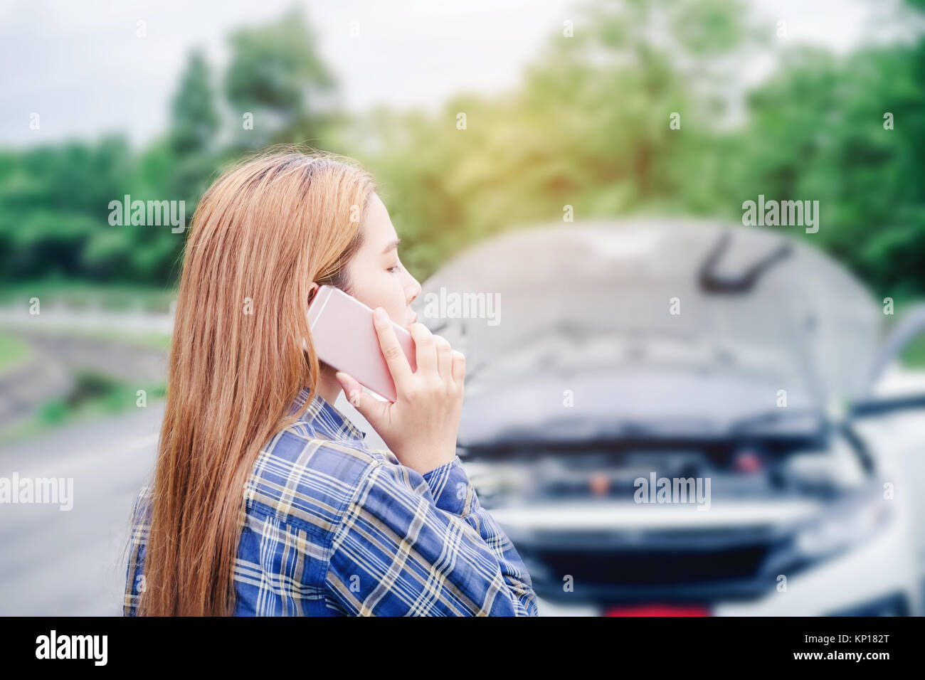 young Woman calling for assistance with his car broken down by the ...