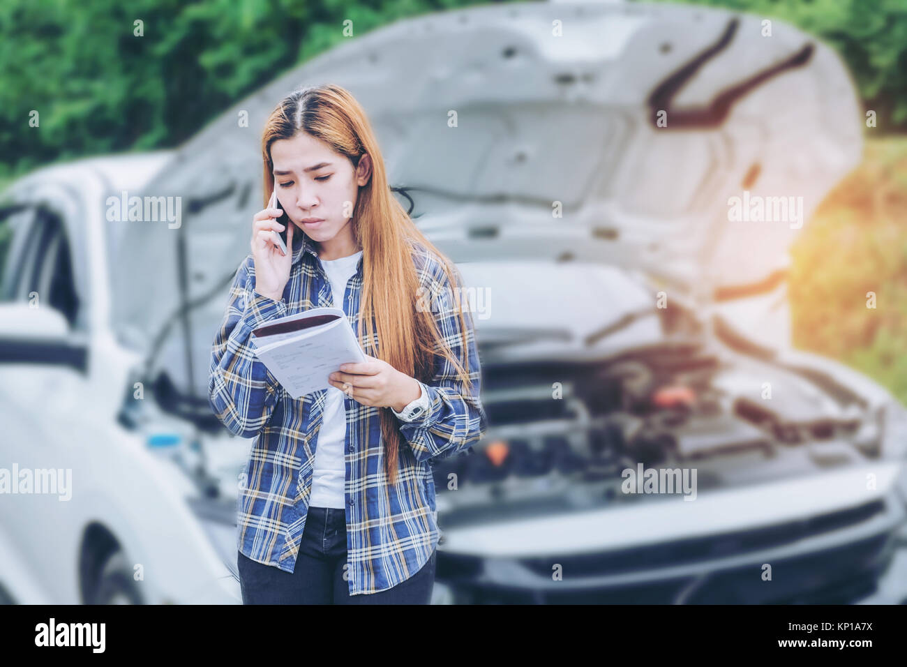 young Woman calling for assistance with his car broken down by the ...