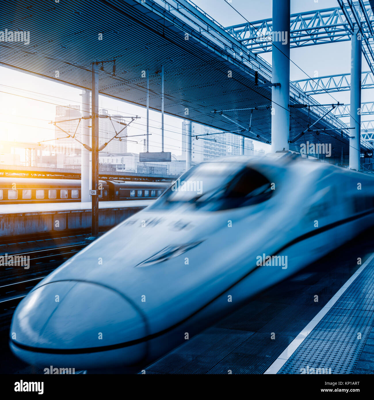 Blurred view of train leaving platform in city of China. Stock Photo