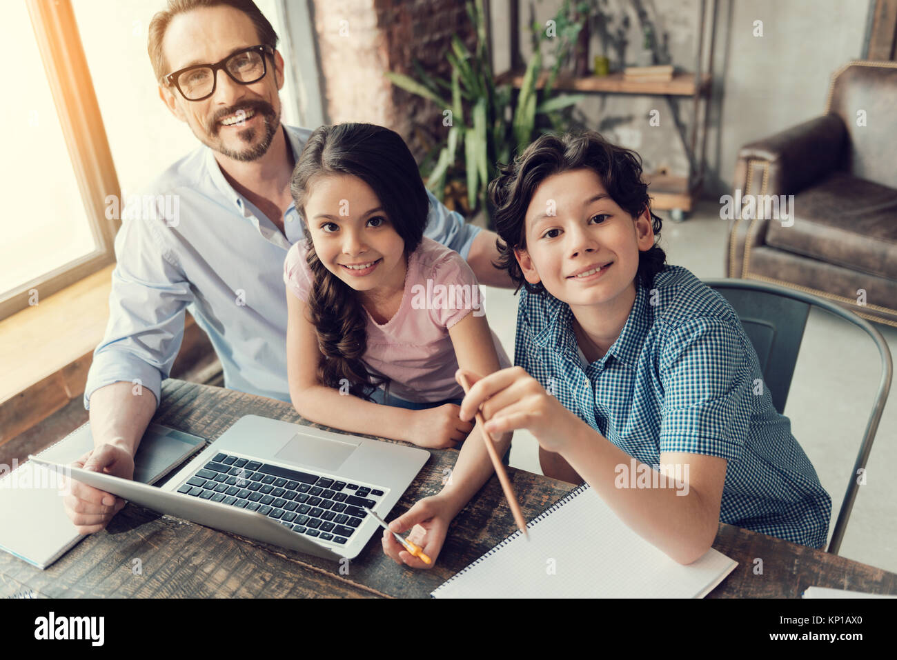 Cute positive children sitting in front of the laptop Stock Photo - Alamy