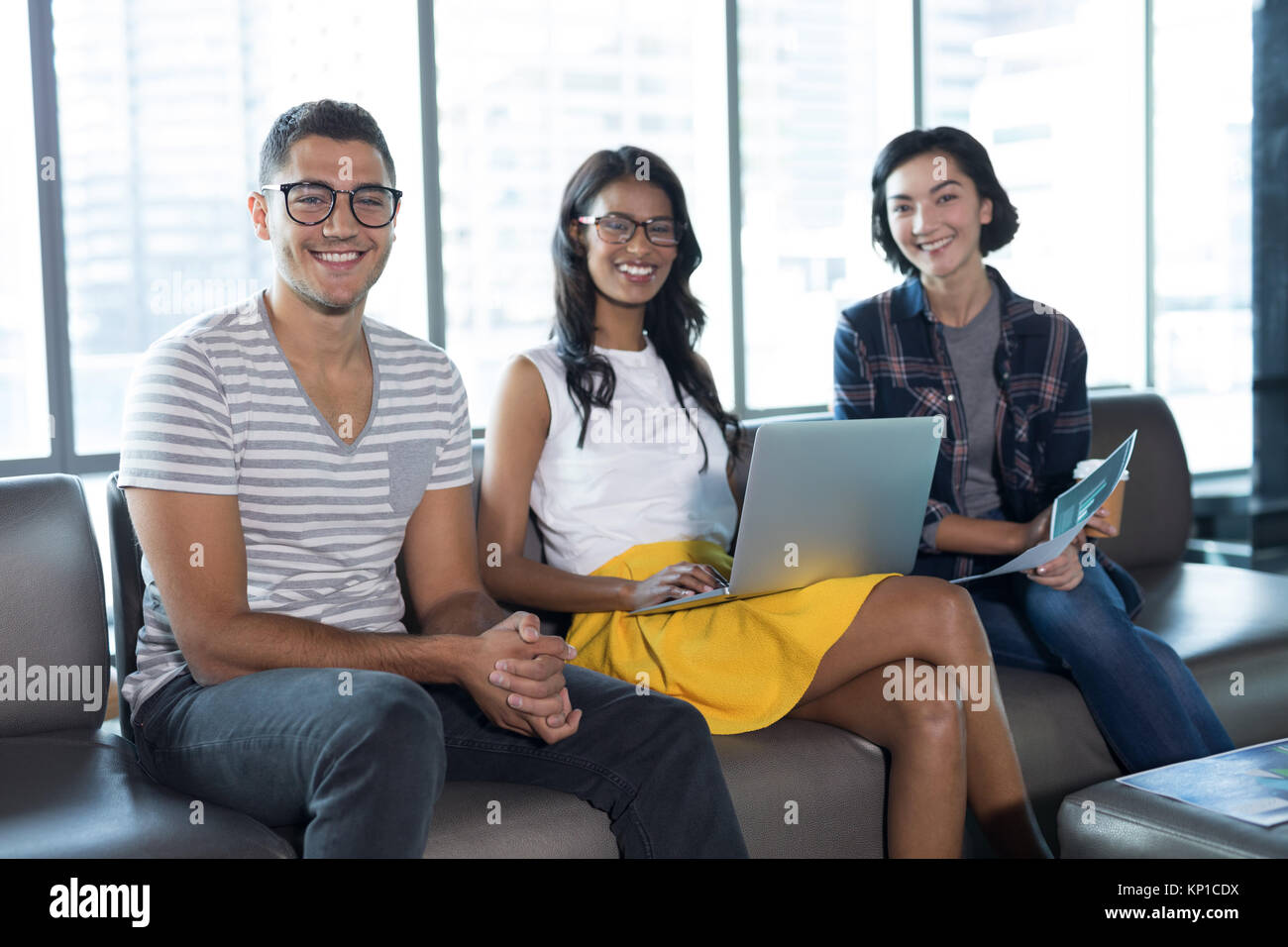 Portrait of smiling executives working together in office Stock Photo ...